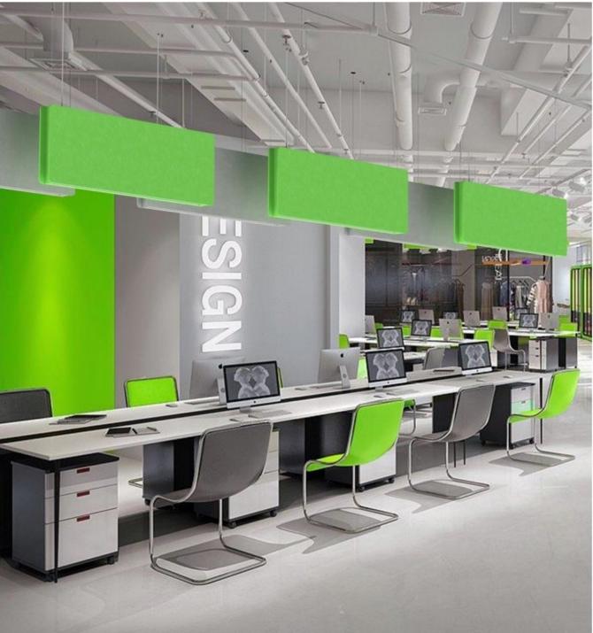 Green acoustic linear baffle lights installed above office workstations